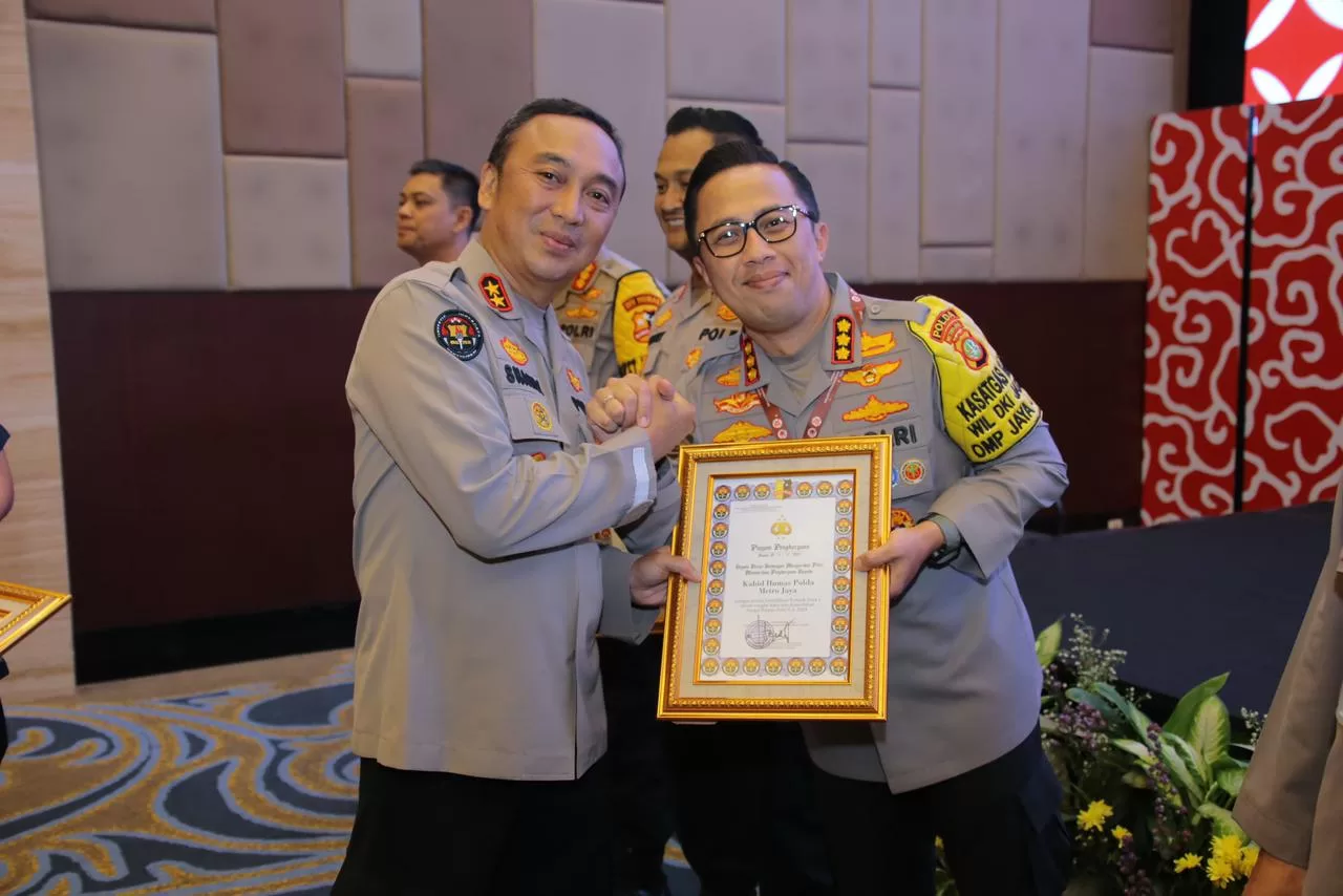 Kabid Humas Polda Metro Jaya saat menunjukkan Piagam Penghargaan. (Hms)