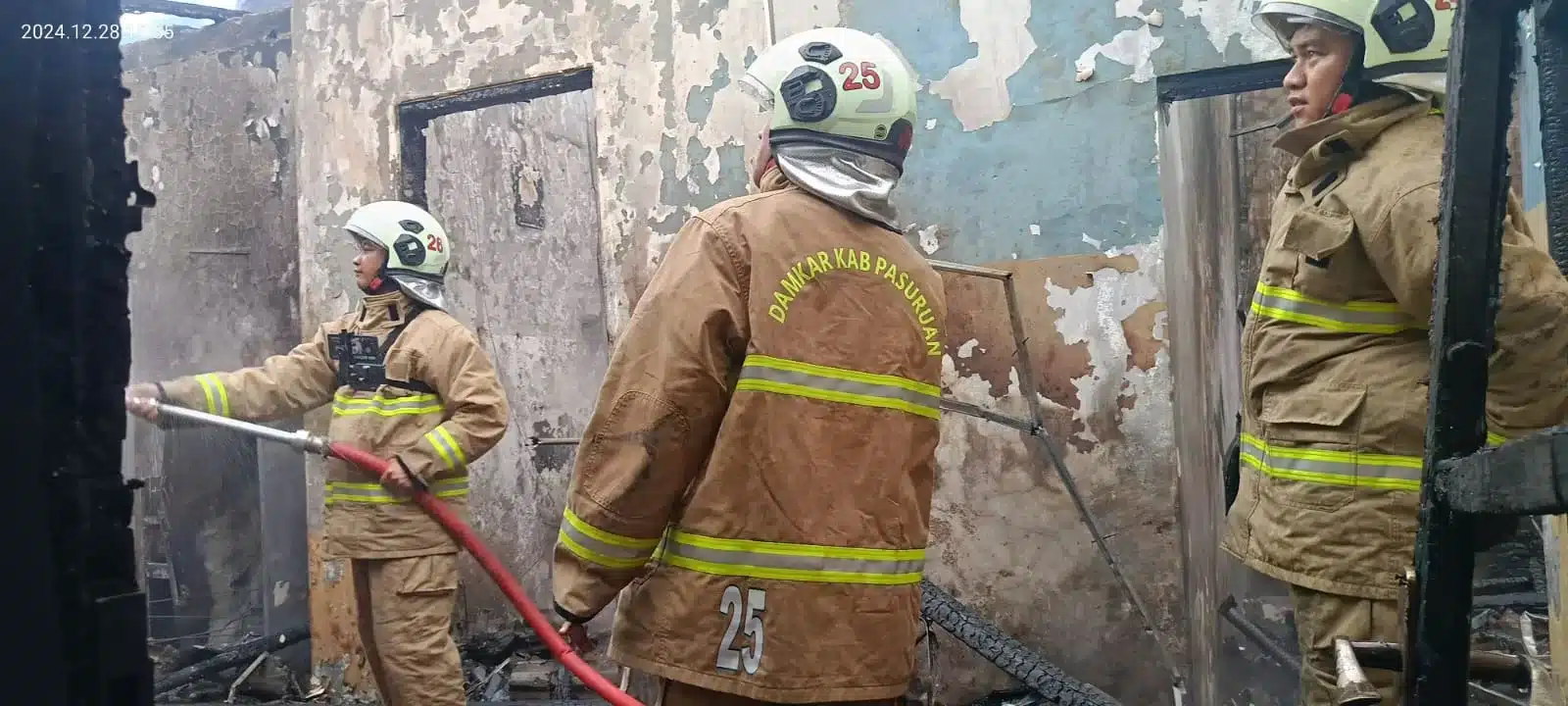Petugas Damkar berjibaku memadamkan api di rumah Surono. (BM)