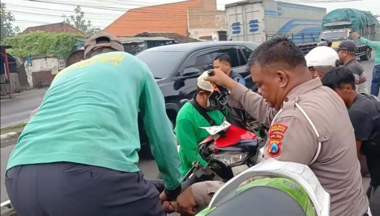 Polisi bersama warga evakuasi motor ke Mobil lantas (BM)