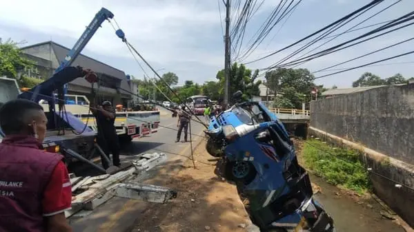 Mobil Elf rombongan besan dari Cibitung masuk kali di Jalan KSU, Sukmajaya, Depok, Minggu (13/9/2026). (Ist)