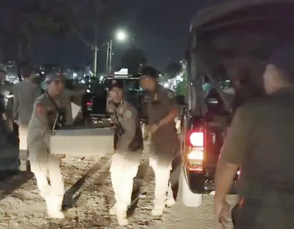 Foto : Satpol PP Kota Pasuruan membawa botol miras ke dalam mobil sitaan dari warga (BM)